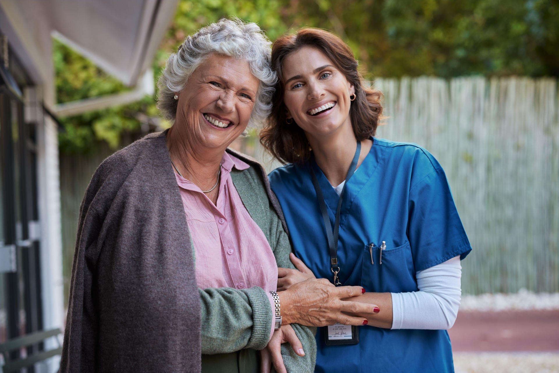 Portrait of senior woman with nurse smiling together